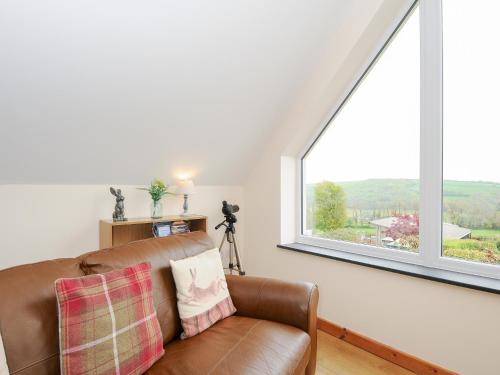 a living room with a couch and a large window at Treview in Launceston