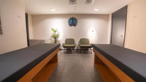 a waiting room with two chairs and a table at Park Inn by Radisson Yalova City Center in Yalova