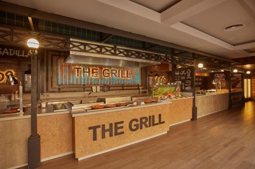 a restaurant with a sign that reads the grill at Bahia Principe Grand Tequila - Adults Only All Inclusive - New Opening Dec 2025 in Akumal