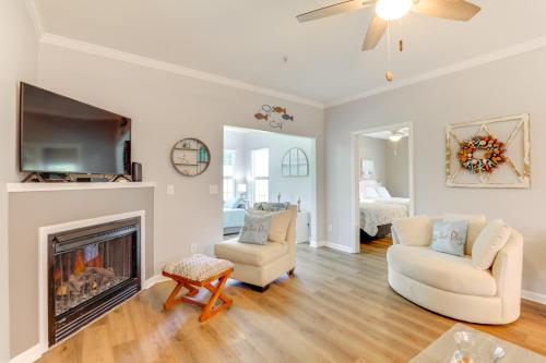 a living room with two chairs and a fireplace at Less Than 2 Mi to Beach Savannah Shores Resort Condo! in Myrtle Beach