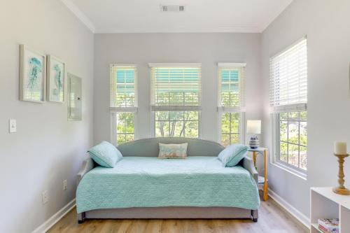 a bedroom with a bed in a room with windows at Less Than 2 Mi to Beach Savannah Shores Resort Condo! in Myrtle Beach