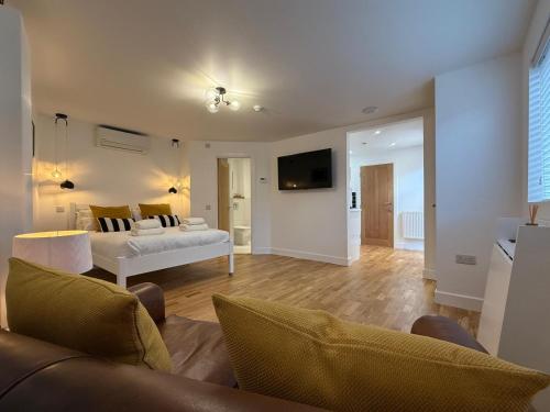a living room with a bed and a couch at Gresham in Kent