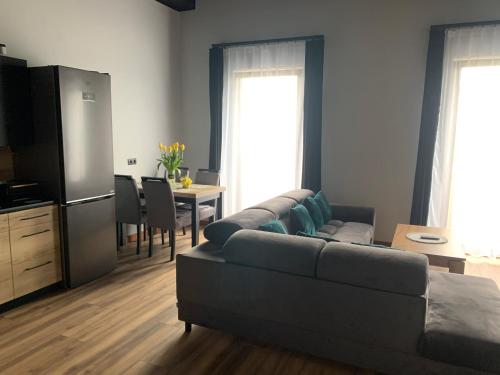 a living room with a couch and a table at Bulwar Apartament Stare Miasto in Głogów