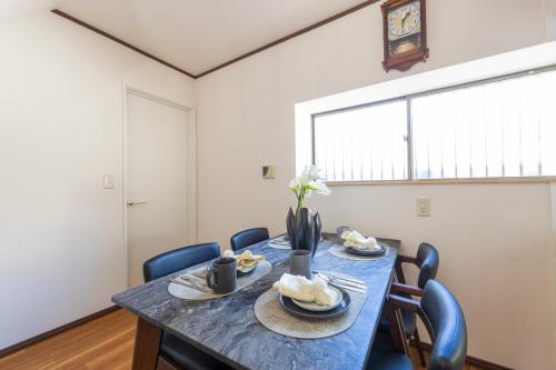 a dining room with a blue table and chairs at Sakura in Tokyo