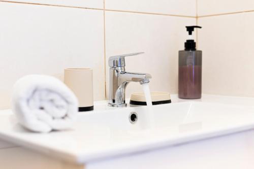 a bathroom sink with a faucet and a soap dispenser at Holiday Home Funchal Center in Funchal