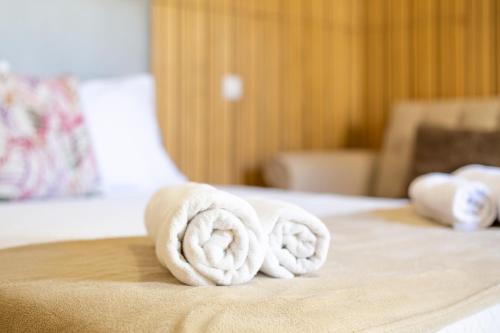 a pile of towels sitting on top of a bed at Holiday Home Funchal Center in Funchal