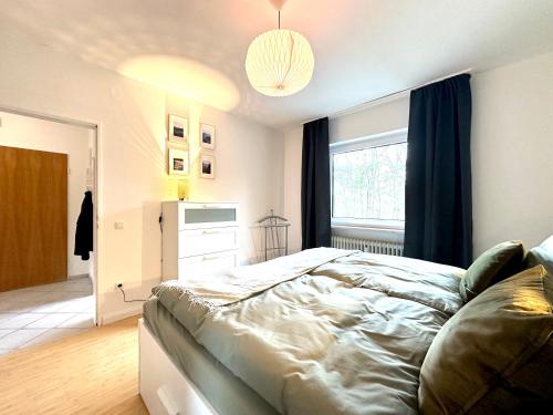 a bedroom with a large bed and a window at HeideHygge 4 in Schneverdingen