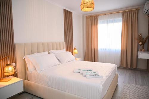 a bedroom with a white bed with two towels on it at Maison de jolie in Golem