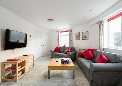 a living room with two couches and a tv at Character House for Buisness, Holidays and Relocation in Frinton-on-Sea
