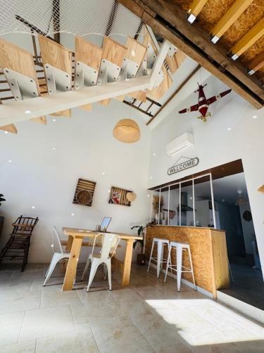 a room with a table and chairs in a building at Le Gite de l Ancre in Ville-sur-Ancre