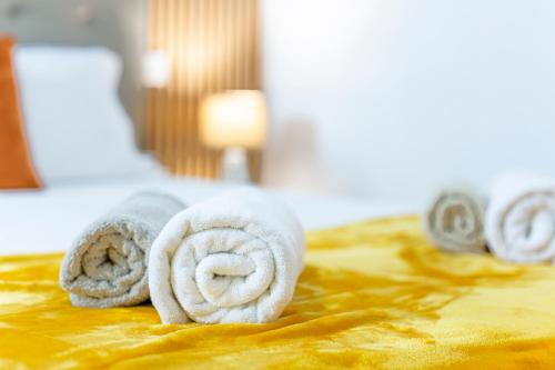 two rolled up towels sitting on a bed at Holiday Home Funchal Center in Funchal