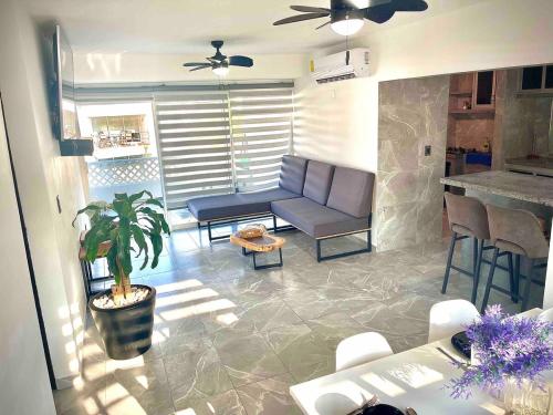 a living room with a couch and a table at Playa Diamante 25 Amazing Family Apartment! in Acapulco