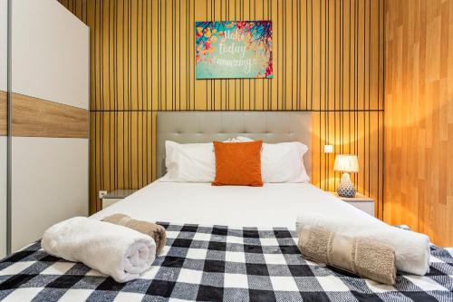 a bedroom with a bed with a checkered blanket at Holiday Home Funchal Center in Funchal