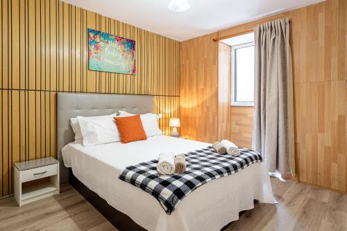 a bedroom with a bed with two towels on it at Holiday Home Funchal Center in Funchal