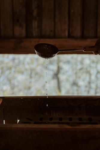 a drop of water is pouring from a spoon at Hotel Bergschlössl in Luson
