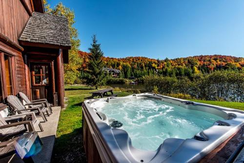 a hot tub in the backyard of a house at Royal Laurentien in Mont-Blanc