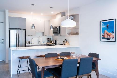 a kitchen and dining room with a wooden table and chairs at Mountainside Revival by Revelstoke Vacations in Revelstoke