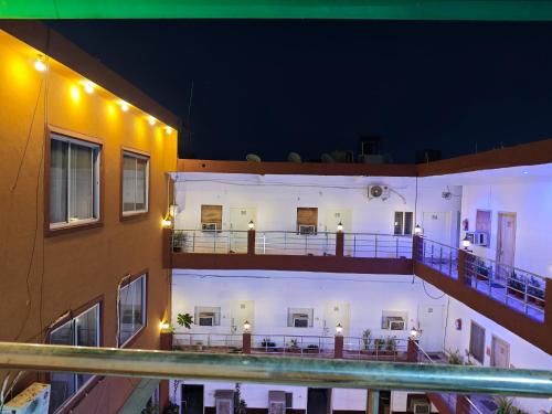 an external view of a building with a pool at night at Raj Hotel - Since 1960 in Sultānpur