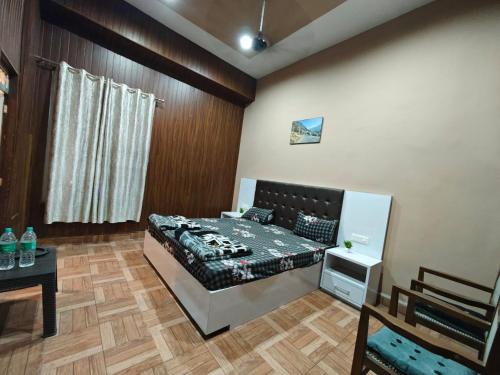 a bedroom with a bed and a table in it at Raj Hotel - Since 1960 in Sultānpur