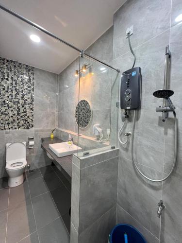 a bathroom with a shower and a toilet and a sink at BungalowD Pool Villa 7R6B with Netflix Great Movies & Dramas in Ipoh