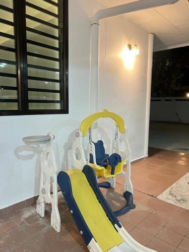 a childs swing in the corner of a room at BungalowD Pool Villa 7R6B with Netflix Great Movies & Dramas in Ipoh