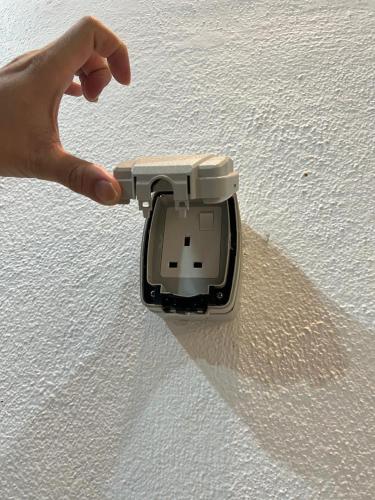 a hand holding a device on top of a table at BungalowD Pool Villa 7R6B with Netflix Great Movies & Dramas in Ipoh