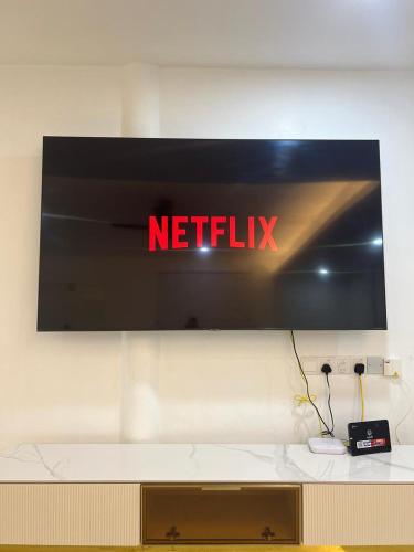 a netflix sign on a wall in a room at BungalowD Pool Villa 7R6B with Netflix Great Movies & Dramas in Ipoh