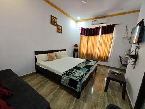 a bedroom with a bed and a tv in it at Raj Hotel - Since 1960 in Sultānpur