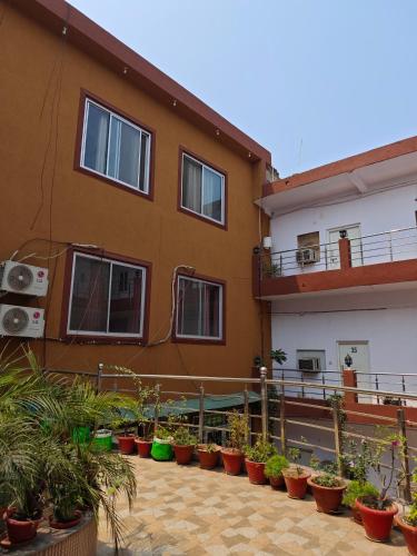 a building with potted plants in front of it at Raj Hotel - Since 1960 in Sultānpur