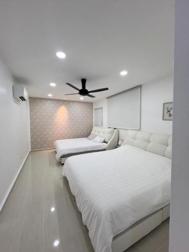 a bedroom with two beds and a ceiling fan at BungalowD Pool Villa 7R6B with Netflix Great Movies & Dramas in Ipoh