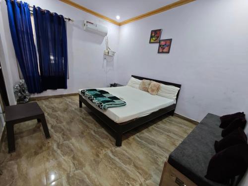 a bedroom with a bed and a couch in it at Raj Hotel - Since 1960 in Sultānpur