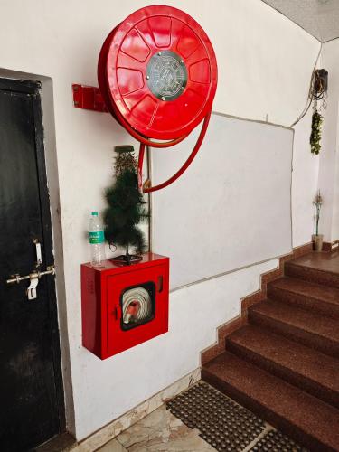 a dog in a washing machine next to a door at Raj Hotel - Since 1960 in Sultānpur