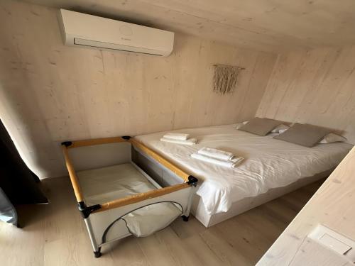 a small bedroom with a bed in a small room at Luxury Seaside Villa Privlaka with Jacuzzi and sauna - 10 Gardens - Beach & Relax Croatia in Privlaka