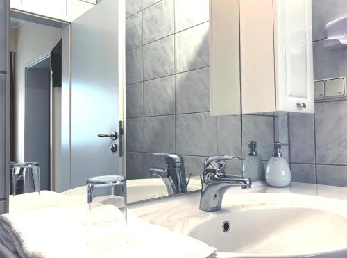a bathroom with a sink and a mirror at Turm Hotel Hanau in Hanau am Main