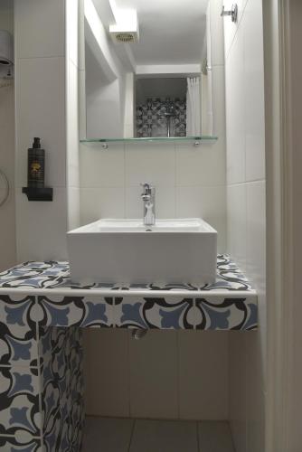 a bathroom with a sink and a mirror at Pension 2Be in Nafplio