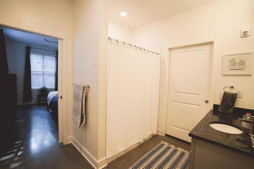 a bathroom with a sink and a toilet and a door at Canyon Stop in Lawrence