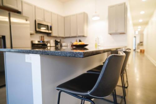 a kitchen with two chairs and a counter with a counter top at Canyon Stop in Lawrence