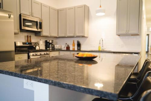 a kitchen with a bowl of fruit on a counter at Canyon Stop in Lawrence
