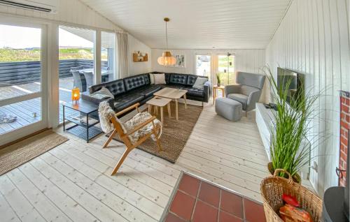 a living room with a couch and a table at Holiday Home Arvidvej Iv in Bjerregård