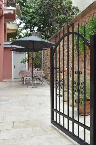 an open gate with an umbrella on a patio at Pension 2Be in Nafplio