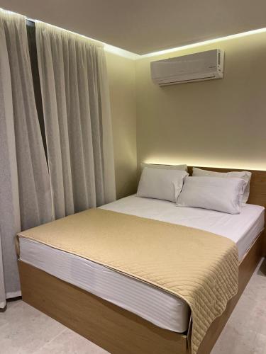 a bedroom with a large bed with a window at Sun gate house in Cairo