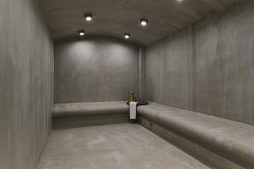 a empty room with a bench in a wall at Mythical Coast Wellness Retreat in Mytilini
