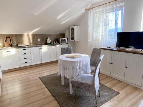 a kitchen with a table and chairs in a room at Ubytovani v Beskydech in Bystrzyca