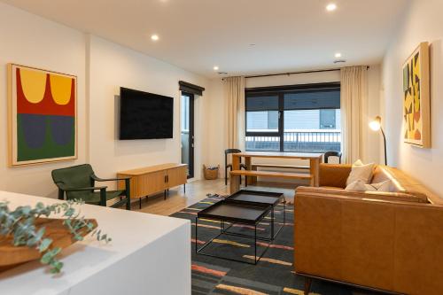 a living room with a couch and a table at Tally Ho by Revelstoke Vacations in Revelstoke