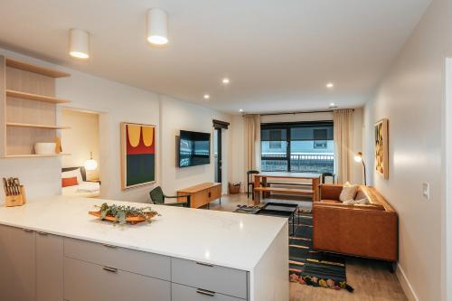 a kitchen and living room with a couch and a table at Tally Ho by Revelstoke Vacations in Revelstoke