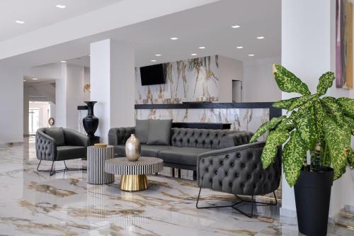 a living room with a couch and chairs and a table at Mythical Coast Wellness Retreat in Mytilini