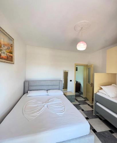 a bedroom with a large white bed with a bow on it at Bellavista Villa in Durrës