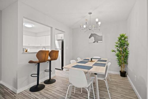 a kitchen and dining room with a table and chairs at Peaceful & Trendy Unit Near Attractions in Rochester Hills