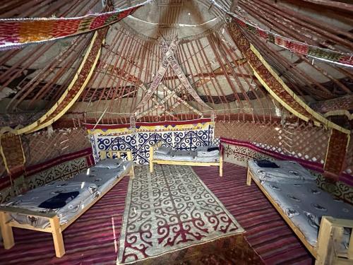 a room with two beds in a yurt at Khansar Family Yurt Camp in Elʼtay