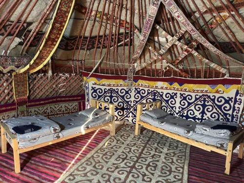 a room with two beds in a yurt at Khansar Family Yurt Camp in Elʼtay